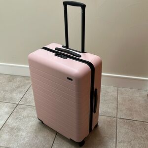 Away The Medium pink rolling luggage suitcase